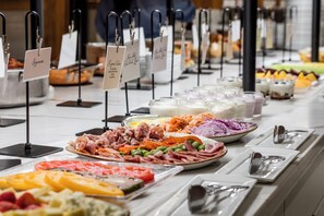 A buffet with various food items and labels indicating different dishes. - Grand Hotel Golf Resort & Spa, Autograph Collection (Fairhope)