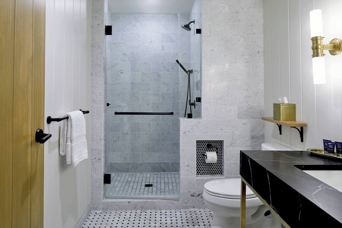 Une salle de bain moderne équipée d’une douche, de toilettes et d’un lavabo.