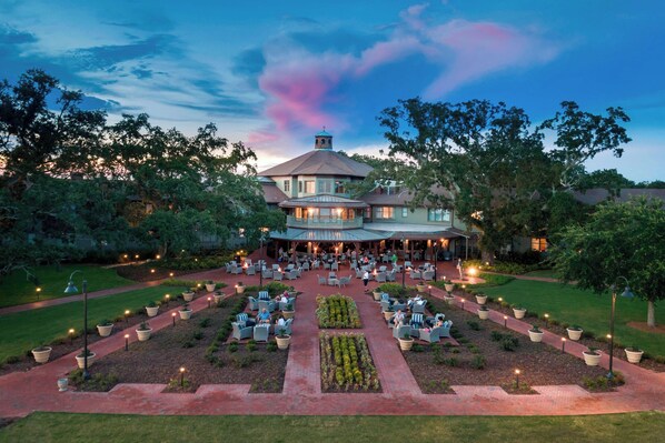 A large, circular building with a central courtyard, surrounded by trees and outdoor seating areas. - Grand Hotel Golf Resort & Spa, Autograph Collection (Fairhope)