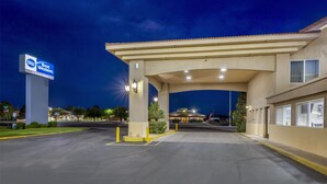 A Best Western hotel entrance at night with a covered parking area and a large sign. - Best Western El Rancho Palacio (Roswell)