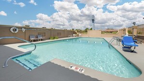 A swimming pool with a lifeguard chair, lounge chairs, and a 4 ft depth sign. - Best Western El Rancho Palacio (Roswell)