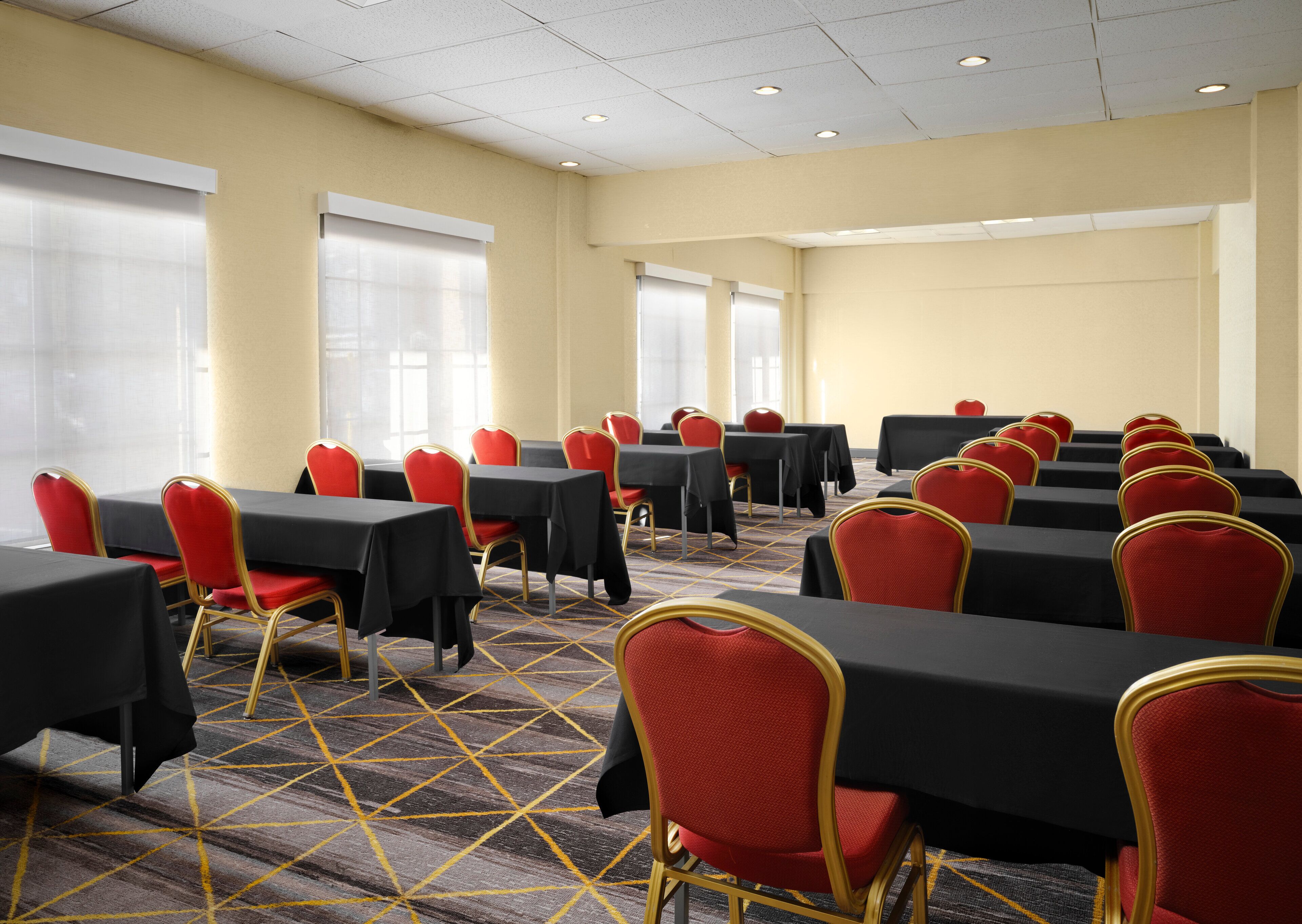 A conference room with tables and chairs arranged for a meeting.