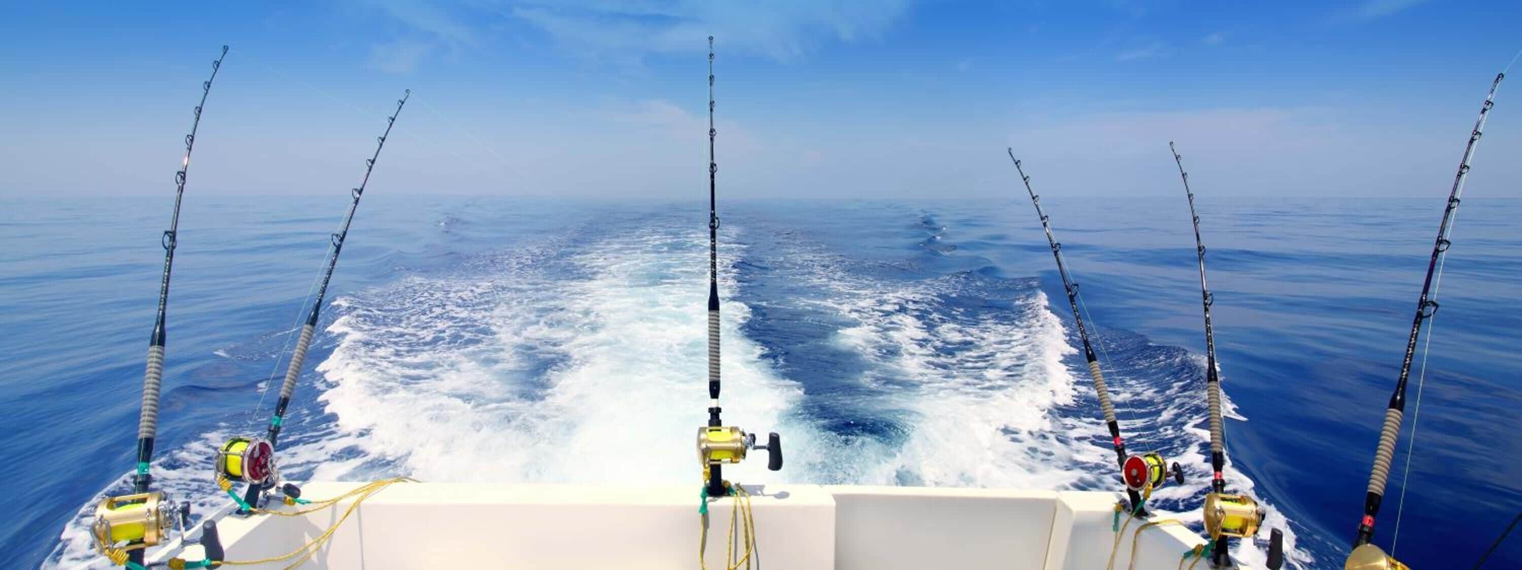 A boat with multiple fishing rods and reels, indicating a fishing activity.