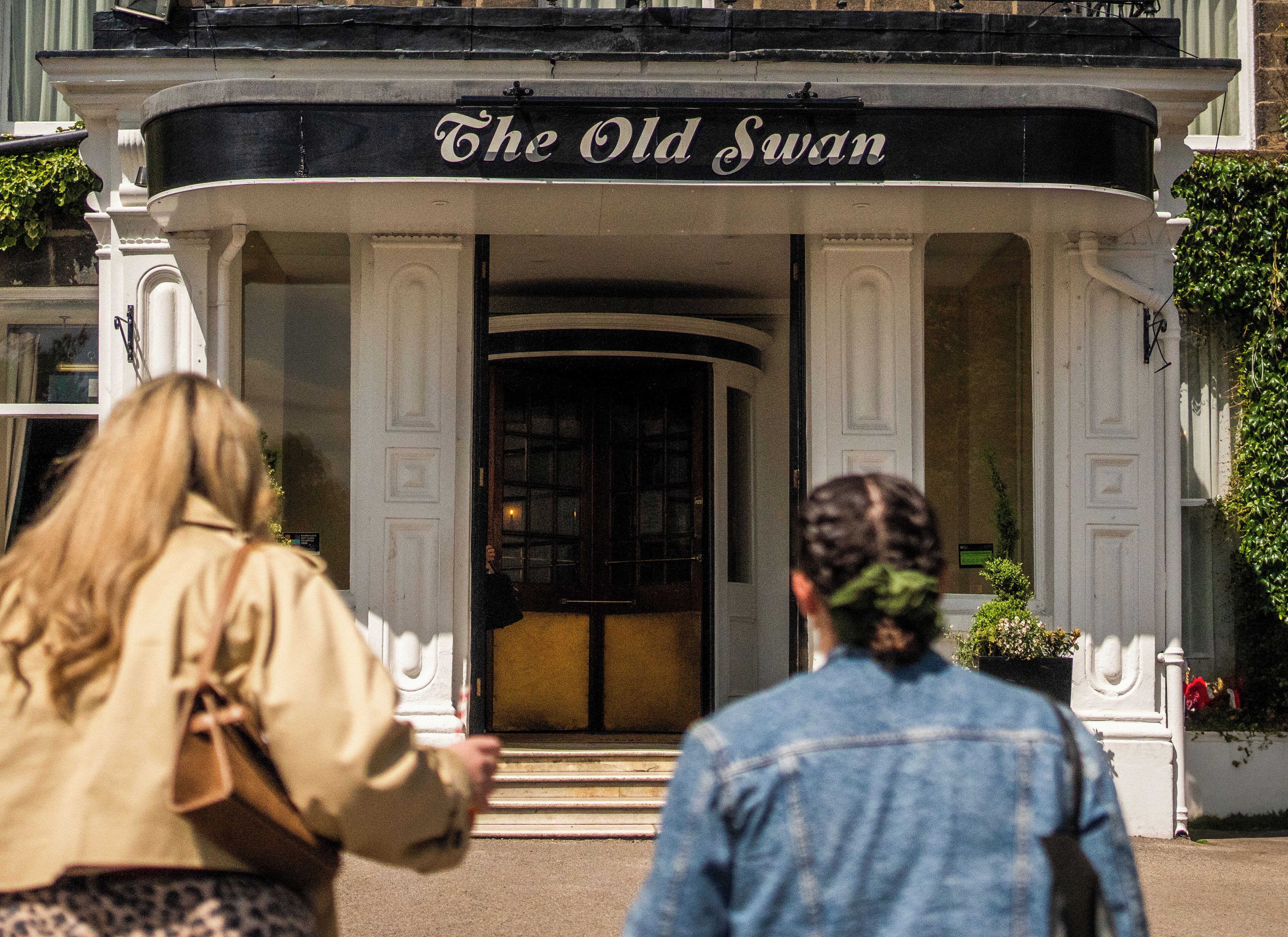 A building with a sign reading "The Old Swan" at the entrance.
