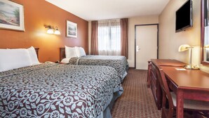 A hotel room with two beds, a desk, a chair, a TV, and a window with curtains. - Red Carpet Inn (Elkton)
