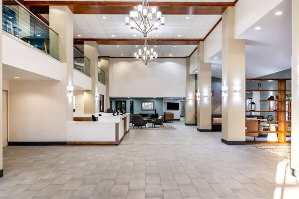 A spacious lobby with a reception desk, seating area, and a chandelier. - Holiday Inn Rock Springs by IHG (Rock Springs)