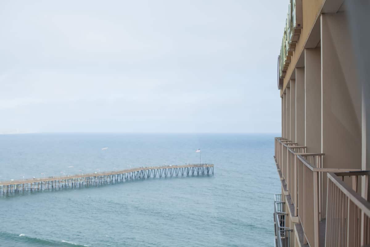 A pier extending into the sea with a building adjacent to it.