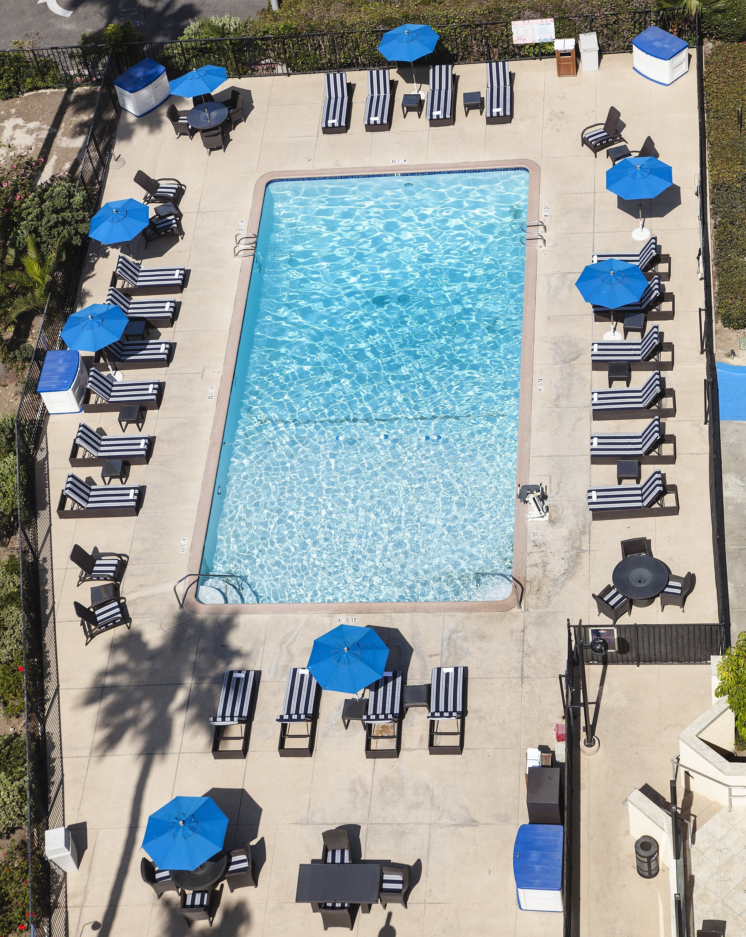outdoor pool, open 9:00 am to 10:00 pm, pool umbrellas, pool loungers