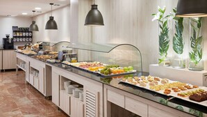 Een buffet met diverse gerechten en een koffiehoek.