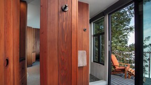 A wooden interior with a sliding glass door leading to an outdoor deck.