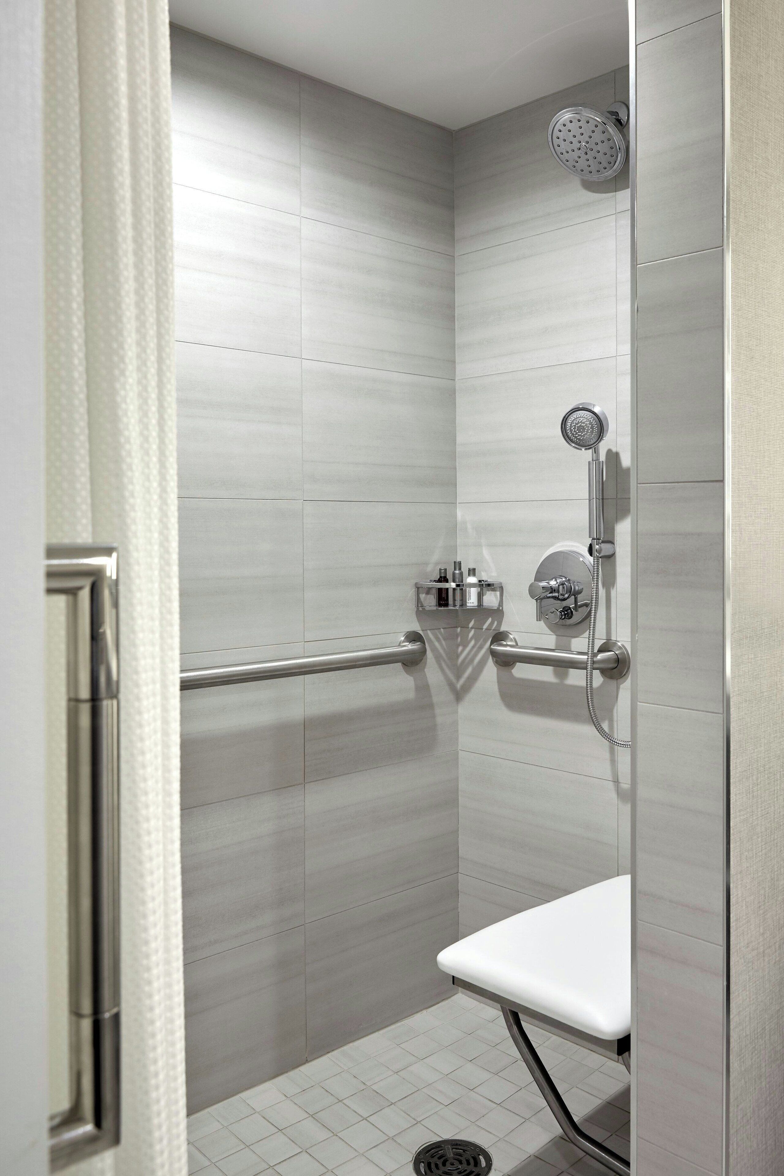 combined shower/bathtub, designer toiletries, hair dryer, bathrobes