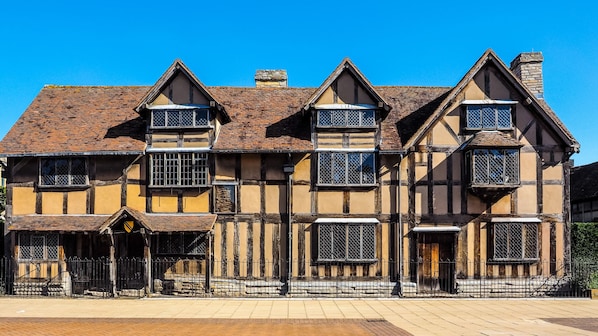 A traditional half-timbered building with multiple windows and a prominent entrance.