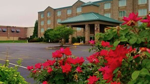 A multi-story hotel with a brick facade, a green roof, and a covered entrance. - Beach Boutique Hotel (Rehoboth Beach)