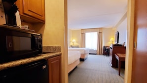 A hotel room with a kitchenette, a bed, a desk, and a bathroom. - Beach Boutique Hotel (Rehoboth Beach)