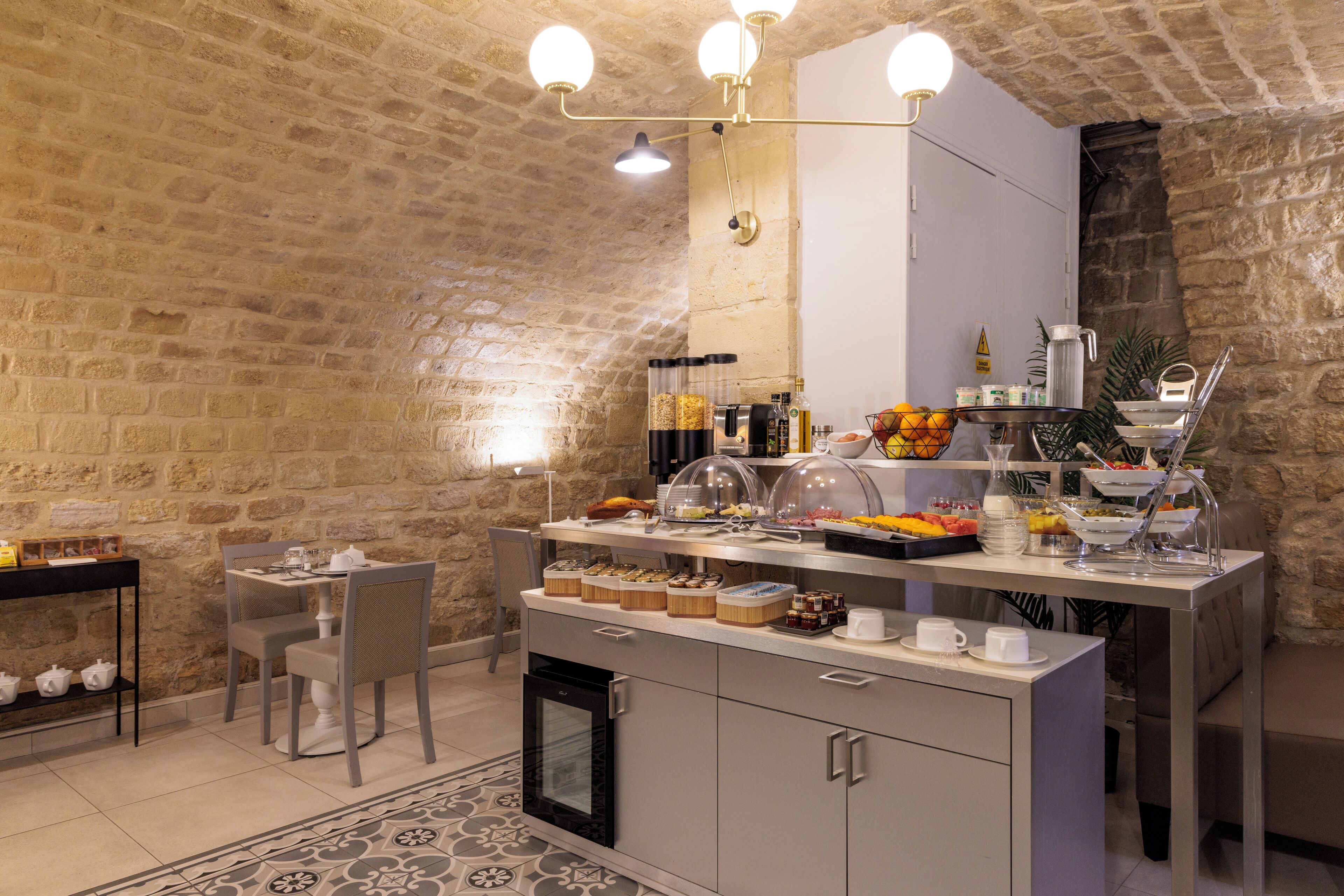 A breakfast bar with various food items and a coffee station.