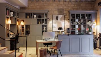 A modern kitchen with a built-in island, a dining area, and a workspace with a computer.