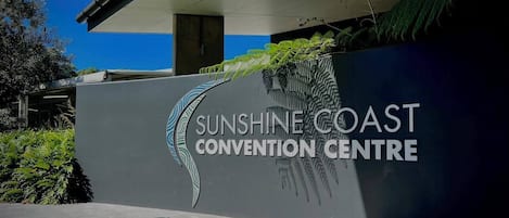 The Sunshine Coast Convention Centre sign with a leaf design.