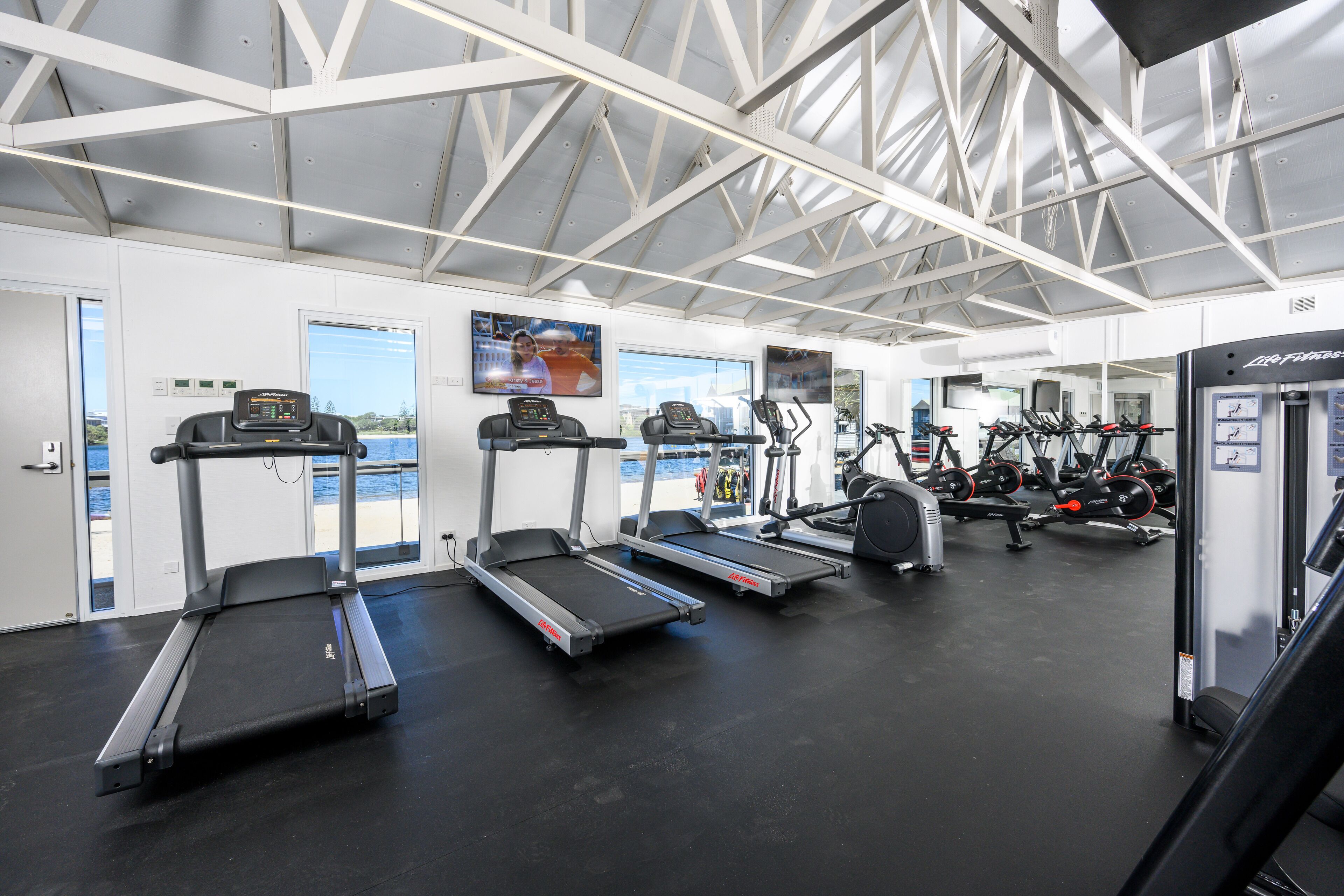 A gym with treadmills, stationary bikes, and weight machines.