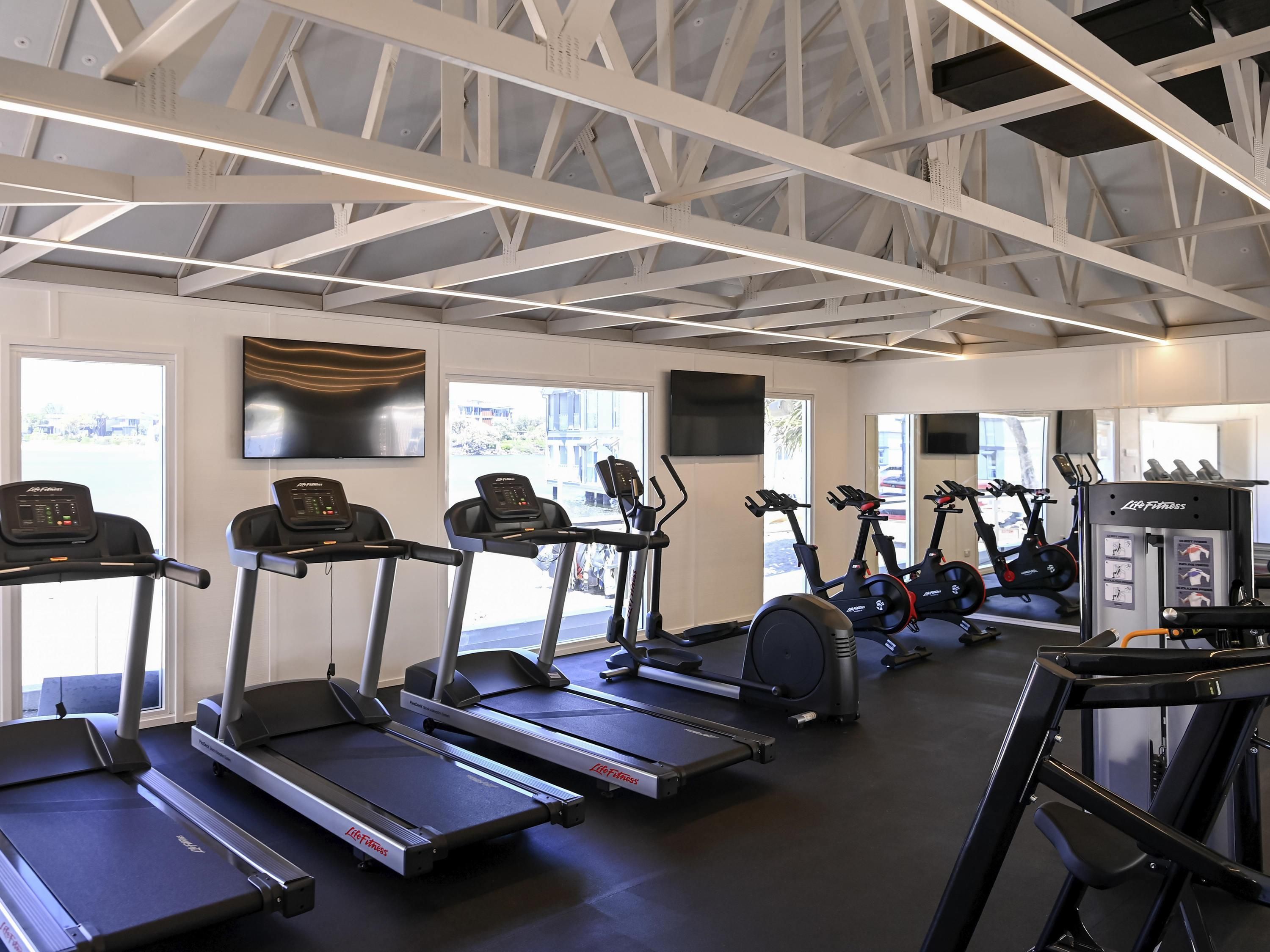 A gym with treadmills, ellipticals, and weight machines.