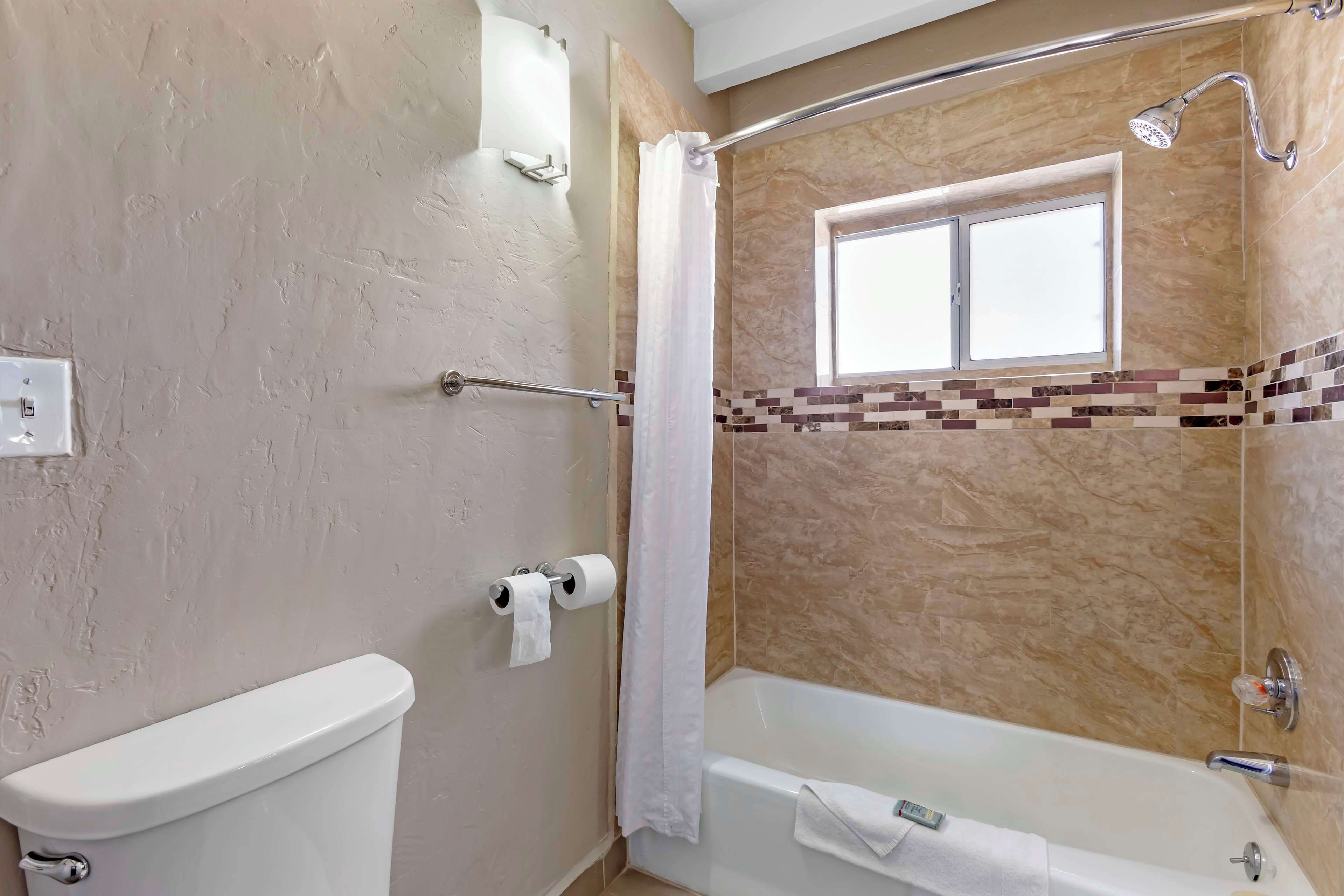 suite, 1 king bed, non smoking, refrigerator & microwave | bathroom | combined shower/bathtub, free toiletries, hair dryer, towels