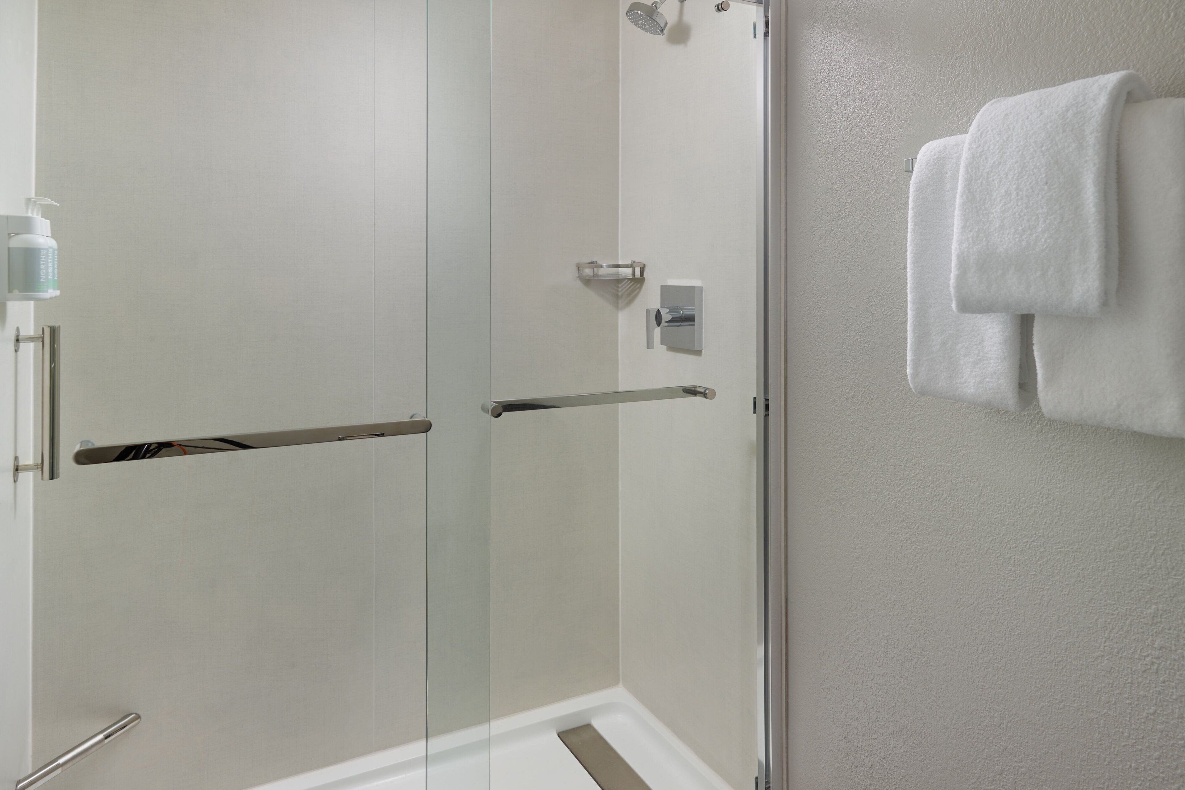 combined shower/bathtub, designer toiletries, hair dryer, towels