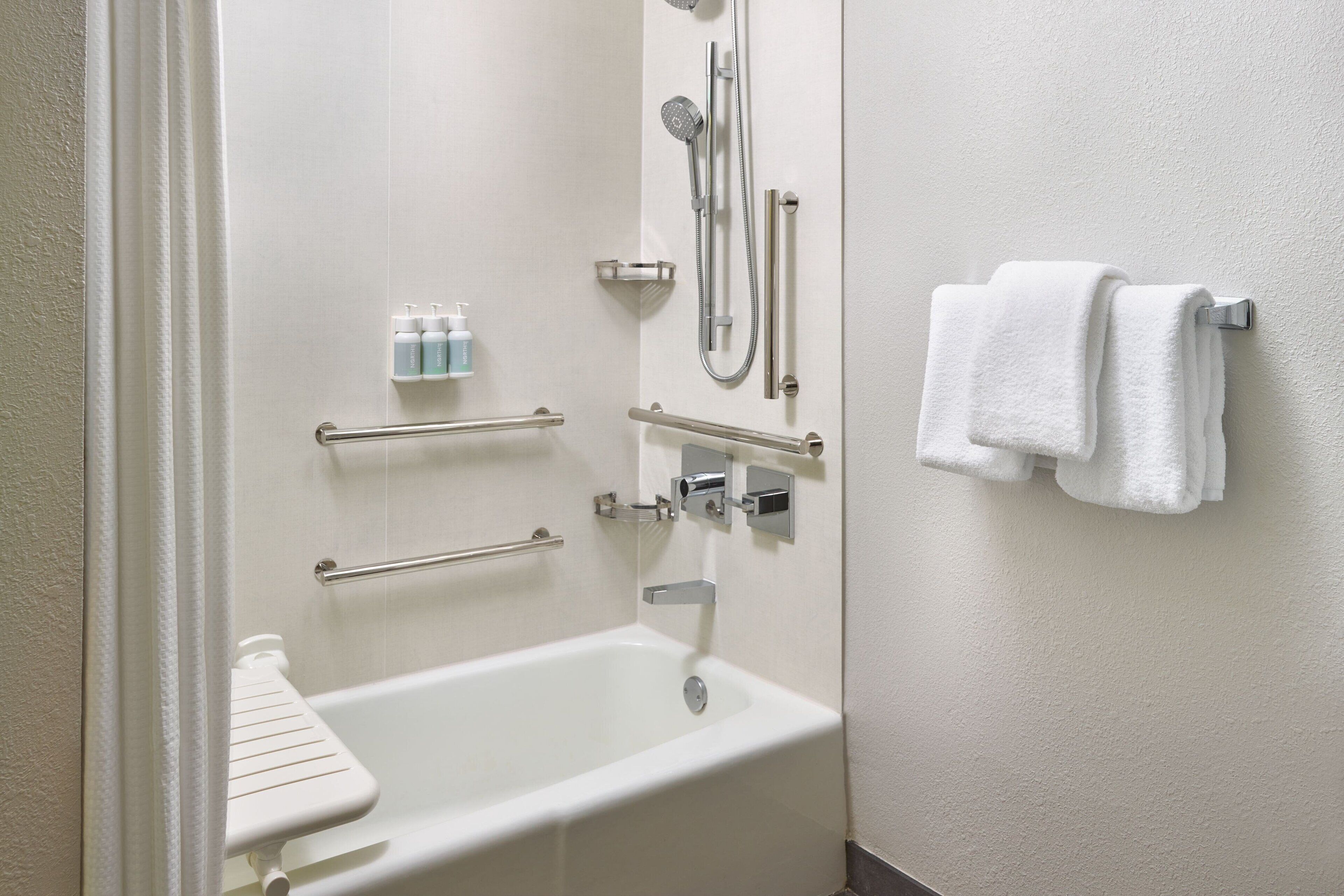 combined shower/bathtub, designer toiletries, hair dryer, towels