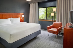 A hotel room with a large bed, a desk, a chair, a TV, and a window with curtains. - Courtyard by Marriott Nashville Brentwood (Brentwood)