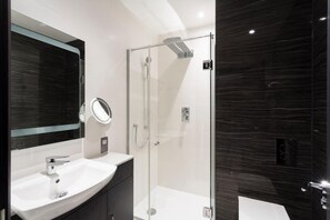 Shower, designer toiletries, hair dryer, bathrobes