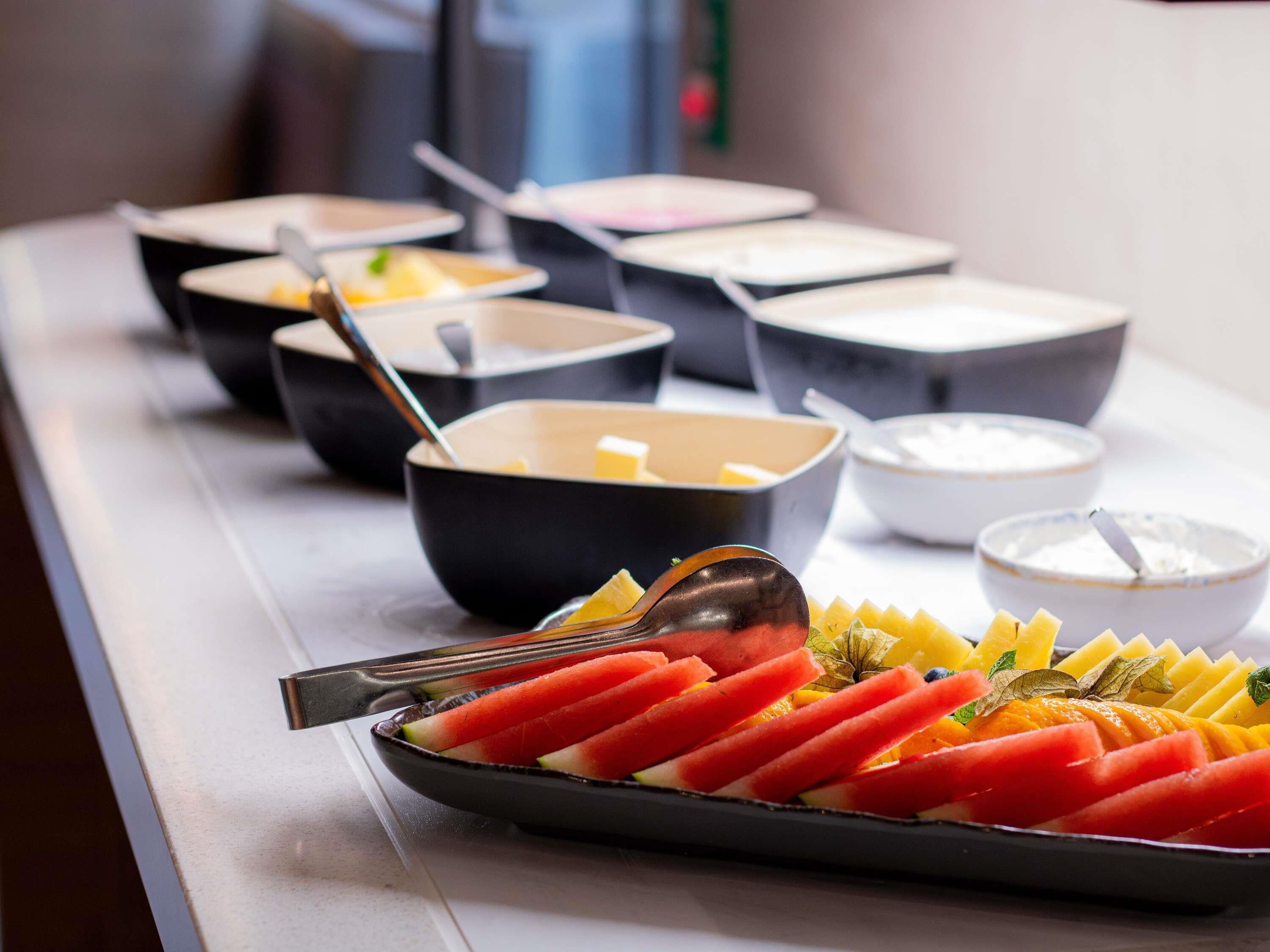 Un buffet proposant divers plats et un assortiment de fruits.