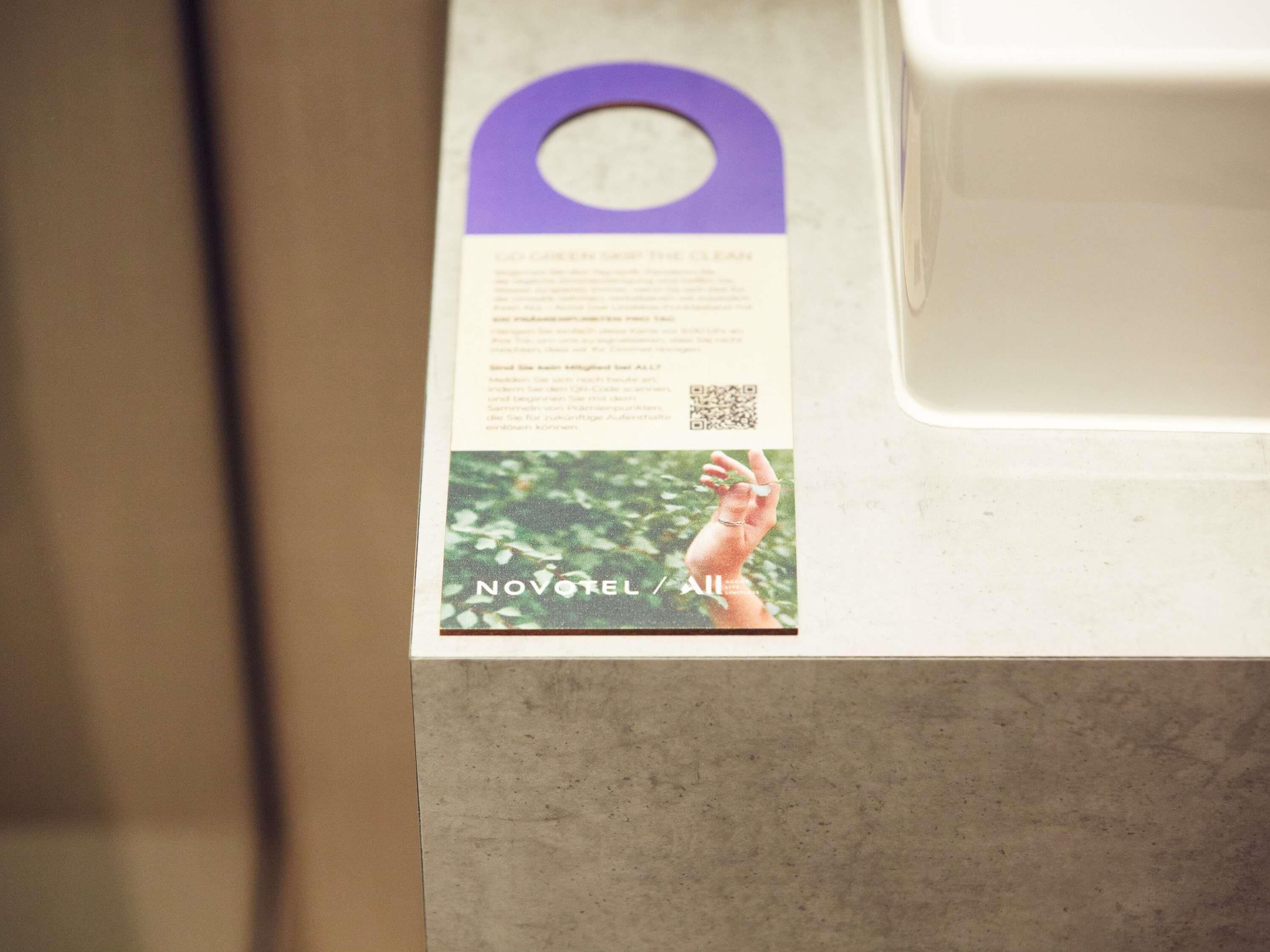 A brochure with text and a QR code, placed on a countertop.