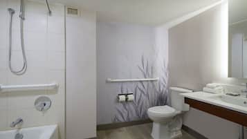 A modern bathroom with a shower, toilet, and bathtub.