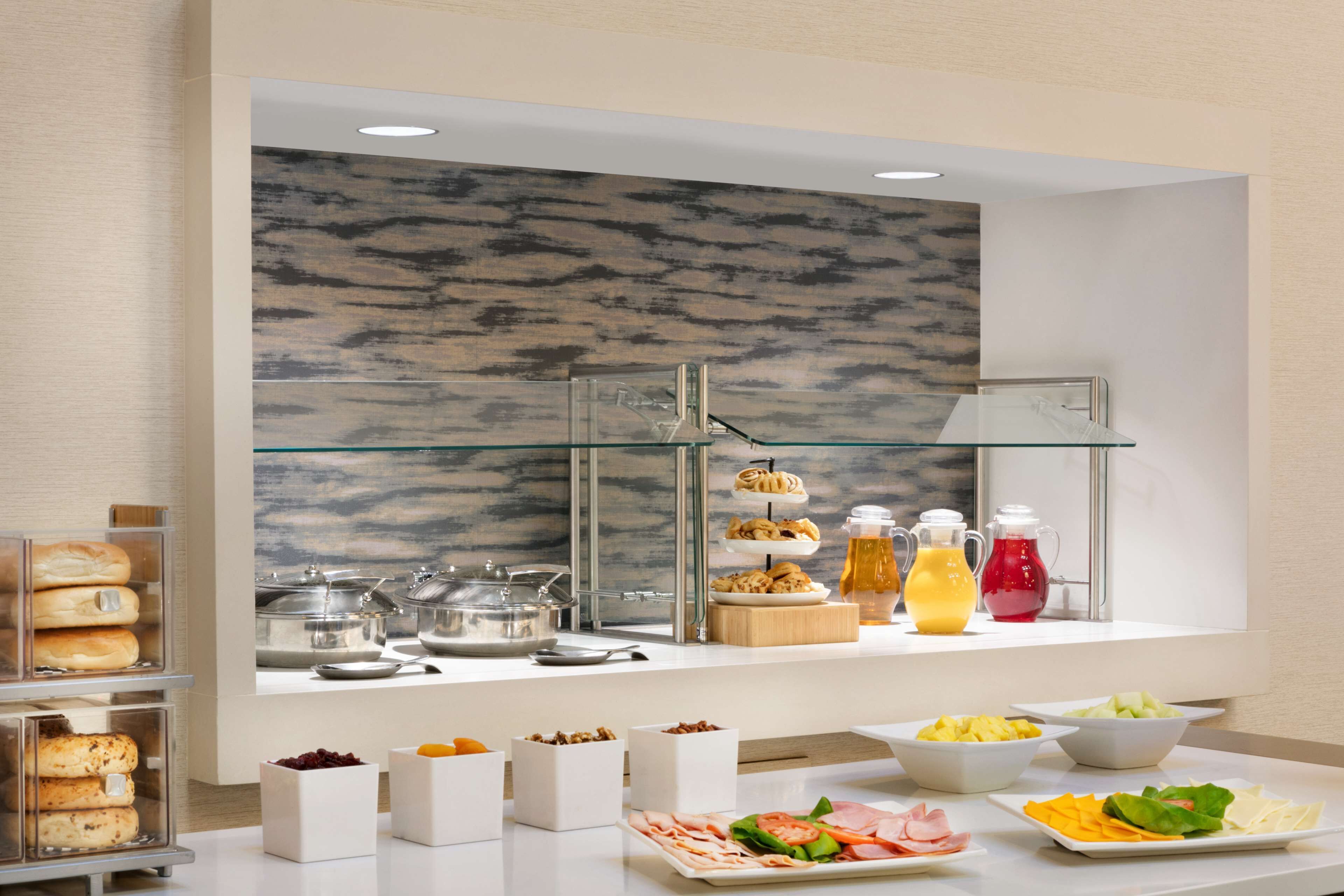 A buffet setup with various food items and beverages.