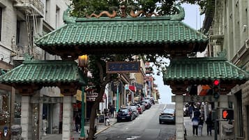 A street with traditional Chinese architecture, including a gate with dragons and a pagoda-style roof.
