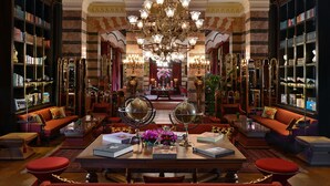 A luxurious library with ornate chandeliers, bookshelves, and comfortable seating areas. - Pera Palace Hotel (Istanbul)