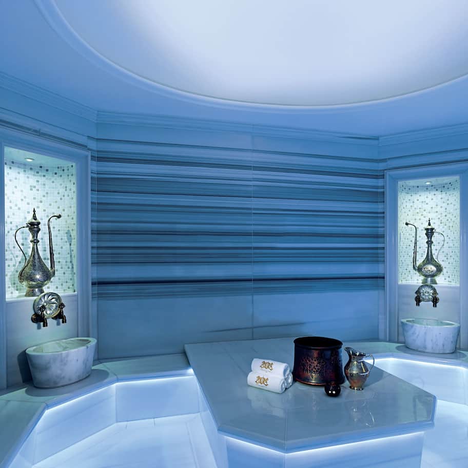 A modern bathroom with a large mirror, a bathtub, and a sink.