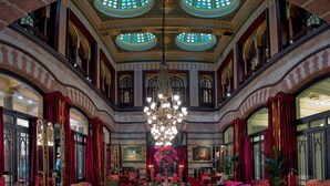 A grand lobby with a chandelier, red upholstered furniture, and ornate ceiling details. - Pera Palace Hotel (Istanbul)