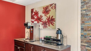 A kitchenette with a coffee machine, a kettle, and a sink. - Red Roof Inn Atlanta - Kennesaw State University (Kennesaw)
