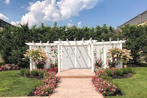 Stroll through the serene garden, lined with vibrant flower beds and a picturesque pergola.