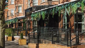 A brick building with multiple windows, a black iron railing, and a tree in the foreground. - The Malone Hotel (Belfast)