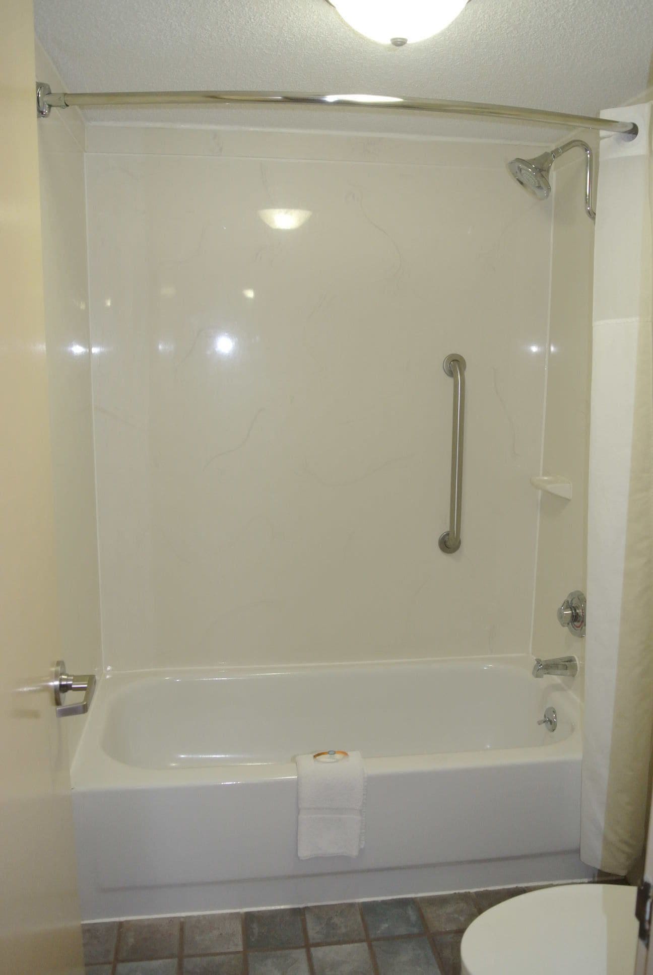 Tina con regadera, secadora de cabello, toallas 