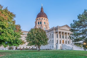 A large, classical building with a prominent dome and columns, surrounded by a well-maintained lawn and trees. - Days Inn by Wyndham Topeka (Topeka)