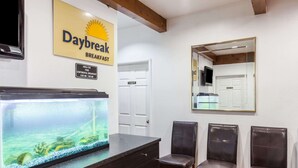 A Daybreak breakfast sign, a fish tank, a private door, and two chairs. - Days Inn by Wyndham Castaic Six Flags Magic Mountain (Castaic)