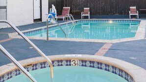 A swimming pool with a tiled edge and a number 31 sign. - Days Inn by Wyndham Castaic Six Flags Magic Mountain (Castaic)