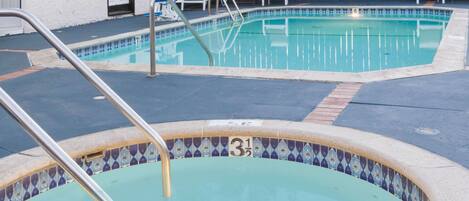A swimming pool with a tiled edge and a number 31 sign.