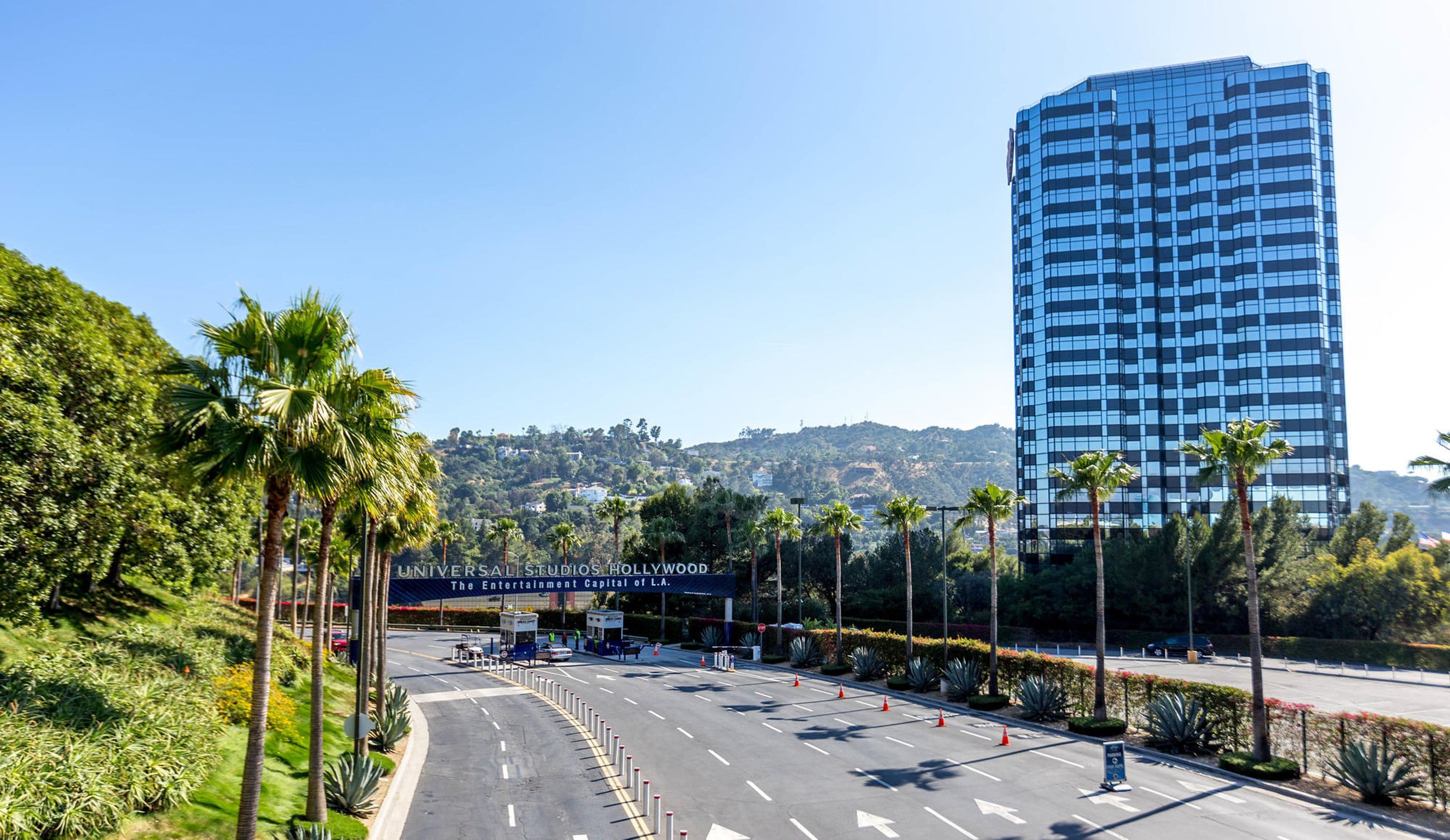 A road leading to a building with a sign reading "Universal Studios Hollywood".