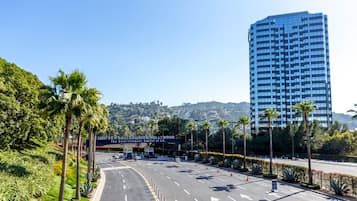 A road leading to a building with a sign reading "Universal Studios Hollywood".