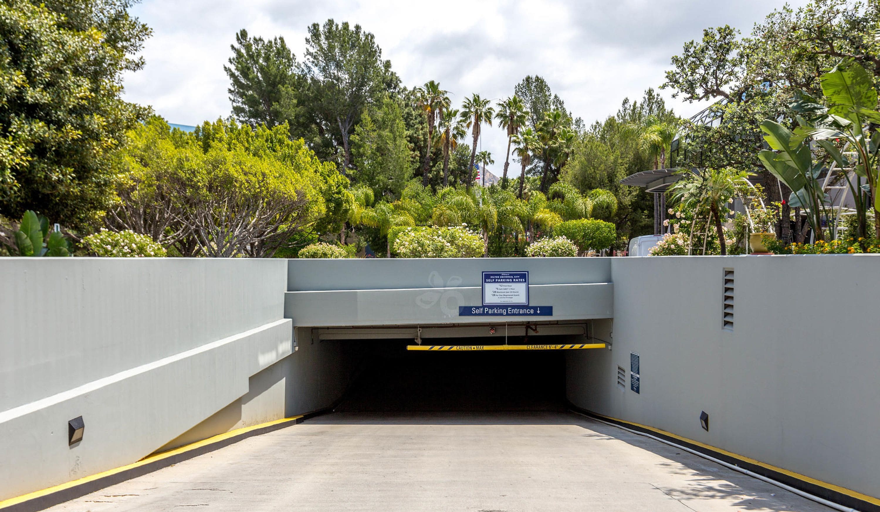A self-parking entrance to a building with a sign indicating self-parking rates.