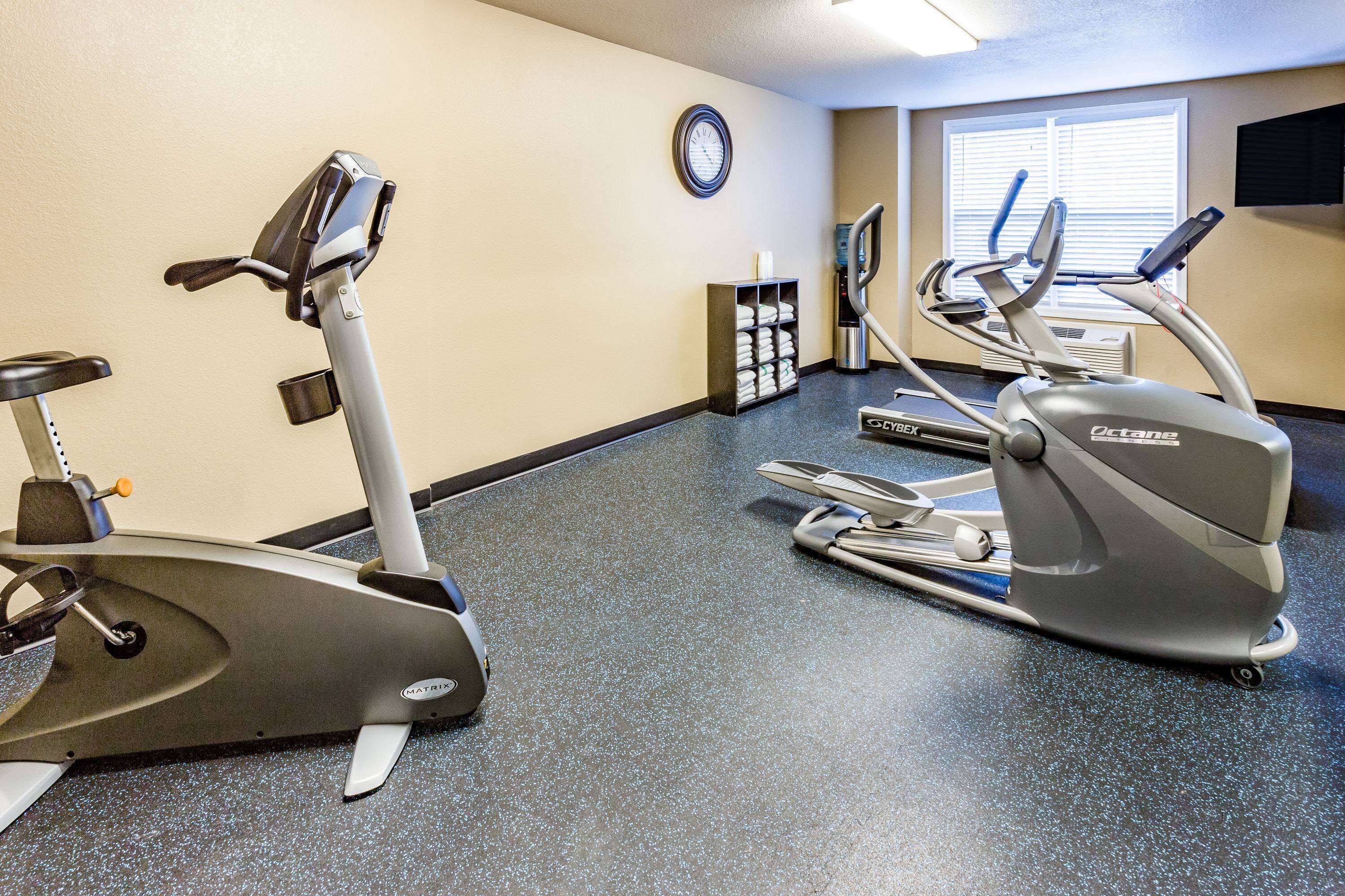 A fitness center with treadmills and an elliptical machine.