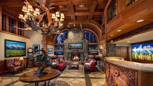 A spacious lobby with a fireplace, leather seating, and artwork on the walls. - The Wyoming Inn of Jackson Hole (Jackson)