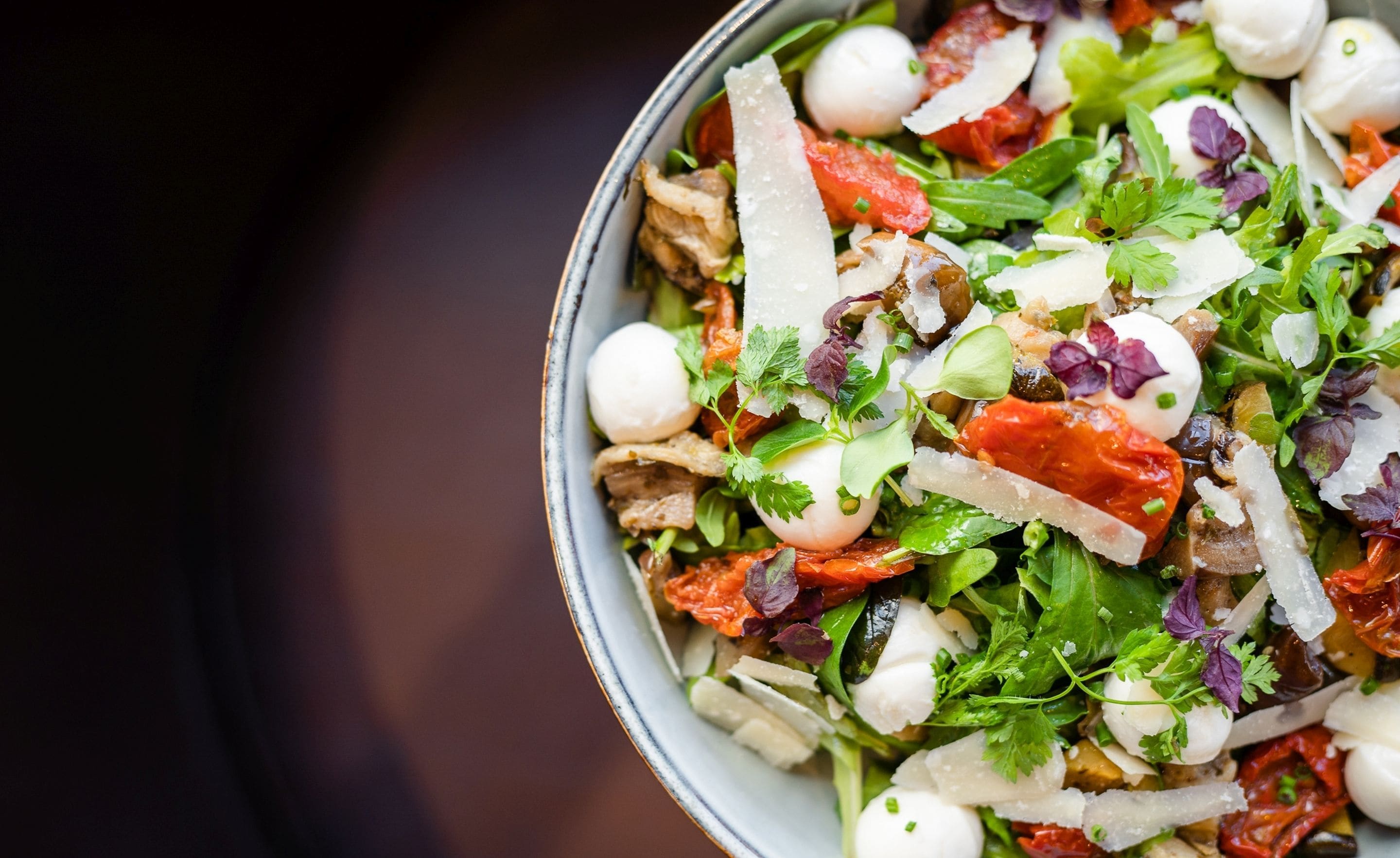 A bowl of salad with various ingredients.